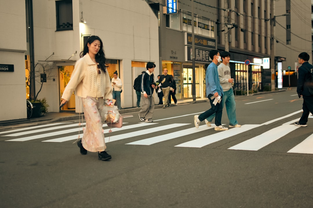 People crossing a street in an urban setting.