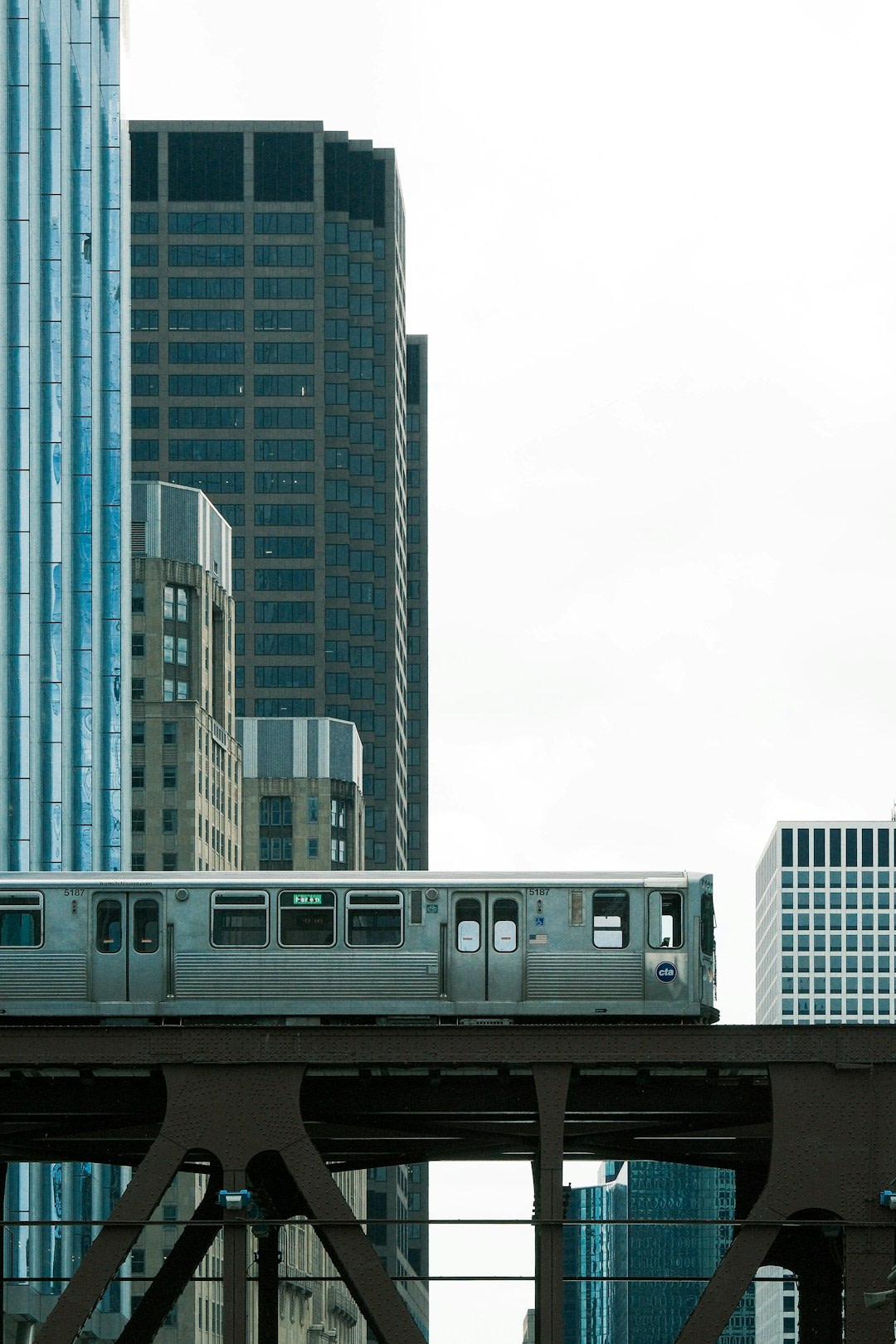 Train travels through a city's high-rise buildings.